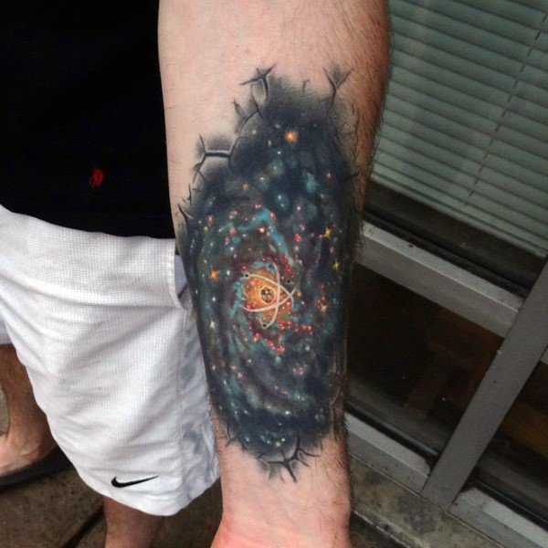 Spectacular looking colored forearm tattoo of space with atom