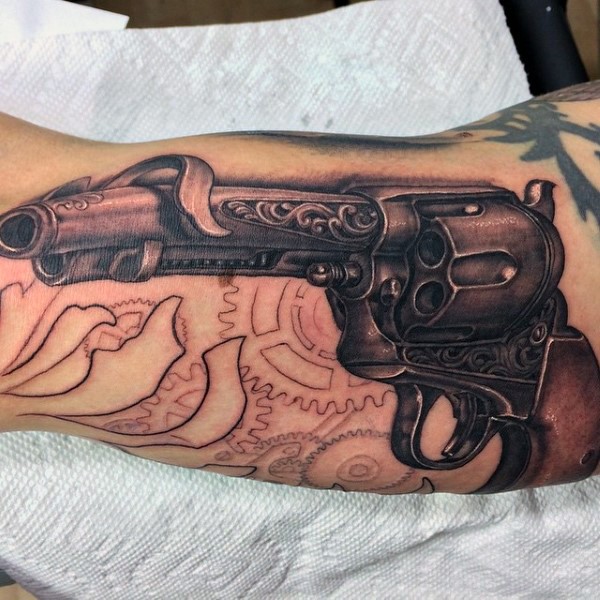 Spectacular looking colored realism style arm tattoo of revolver