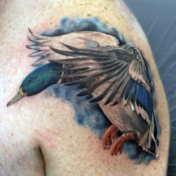 Spectacular looking colored shoulder tattoo of flying duck