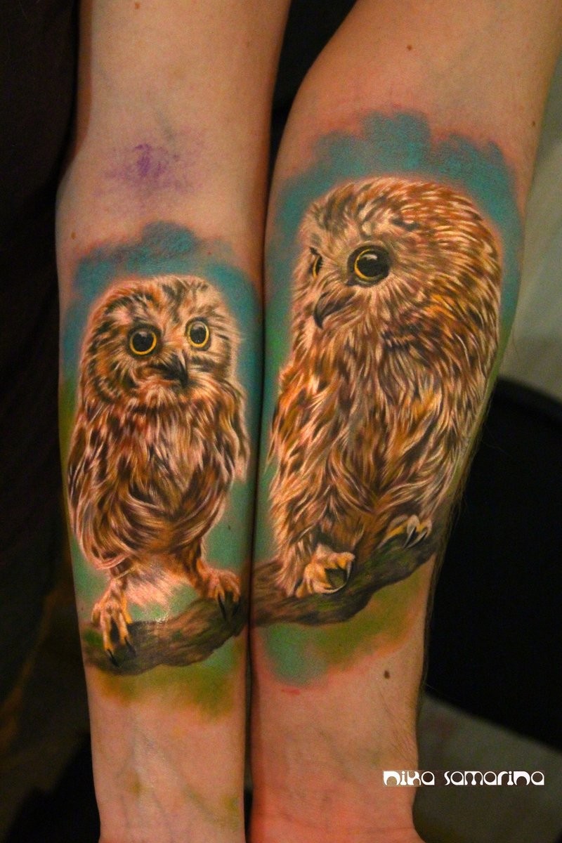 Spectacular looking realism style colored and detailed forearms tattoo of owl babies