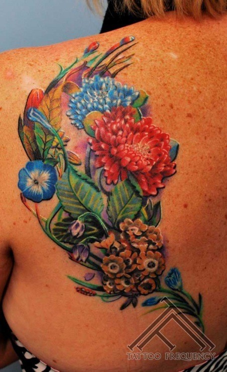 Spectacular multicolored detailed wildflowers tattoo on back