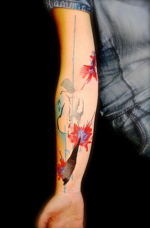 Spectacular multicolored forearm tattoo of abstract flowers