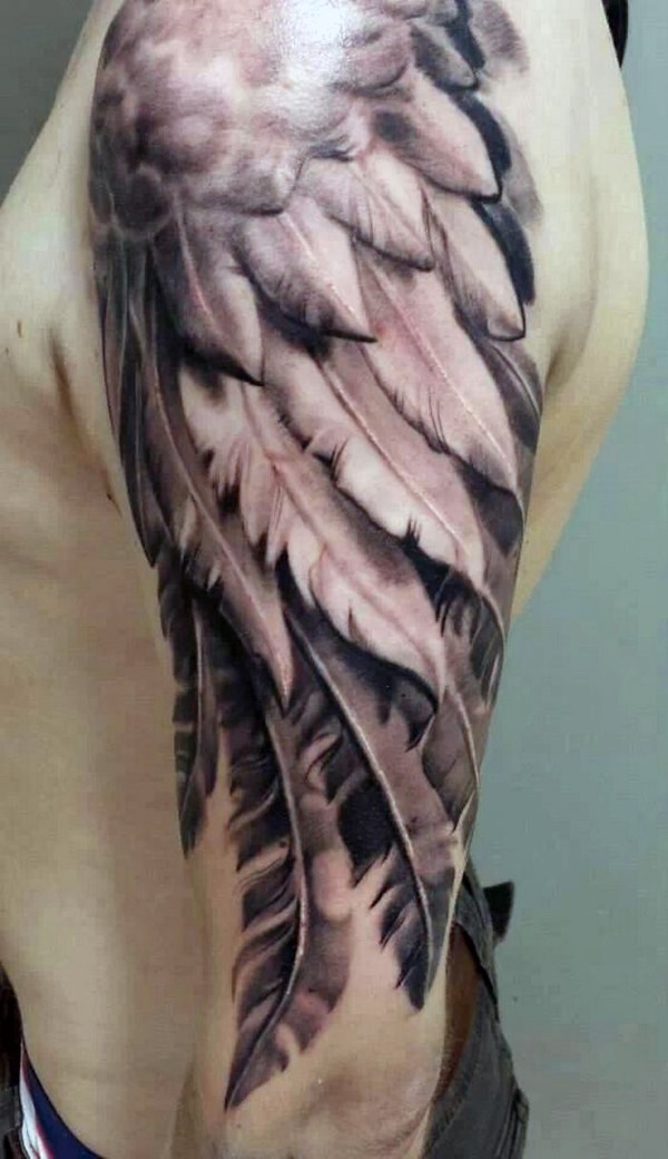 Spectacular natural looking 3D like shoulder tattoo of angel wing