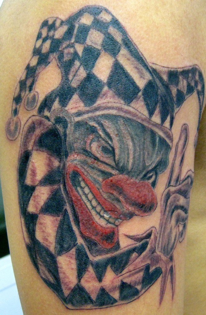 Spiteful clown tattoo on arm