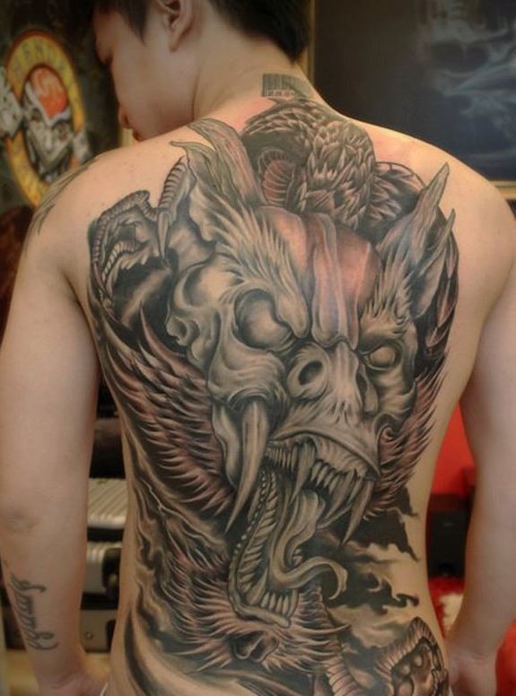Spooky gray dragon tattoo on back