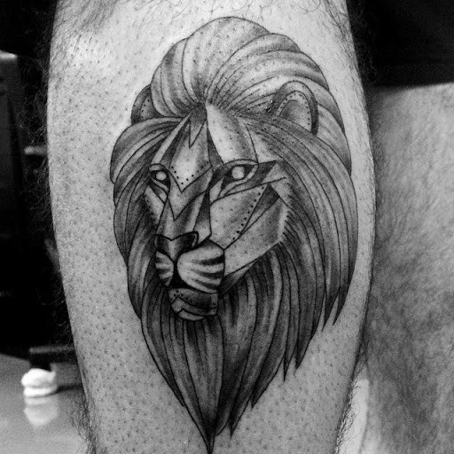 Steel like black ink thigh tattoo of lion