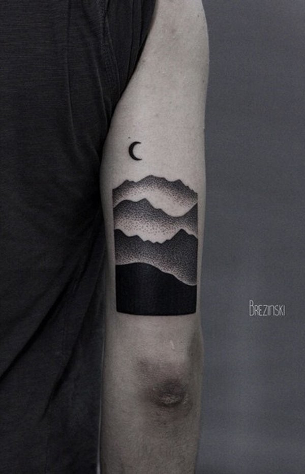 Stippling style black ink arm tattoo of mountains with moon