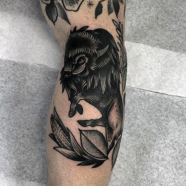 Stippling style black ink arm tattoo of black bull with leaves