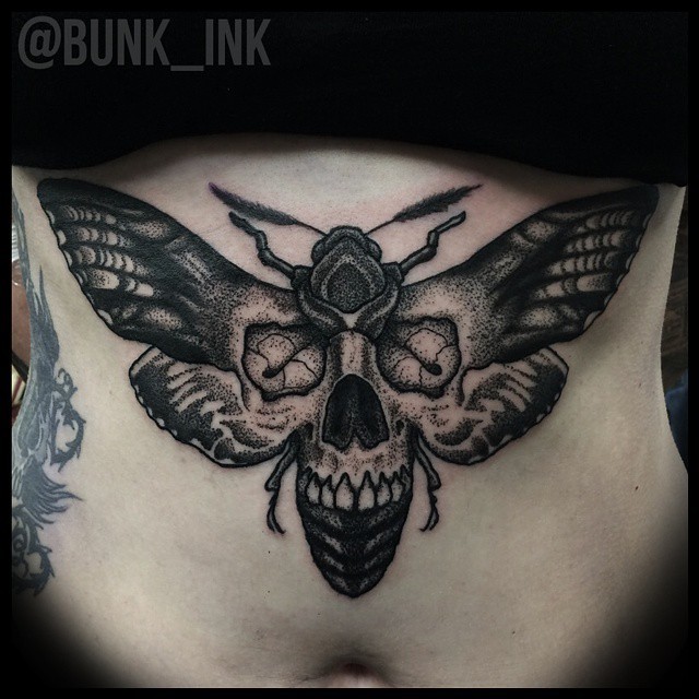 Stippling style black ink belly tattoo of big insect stylized with human skull
