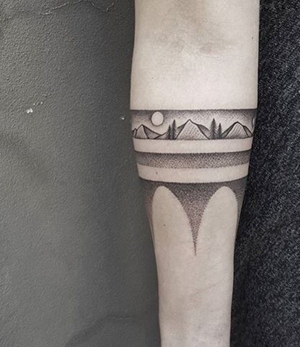 Stippling style black ink forearm tattoo of mountains with sun