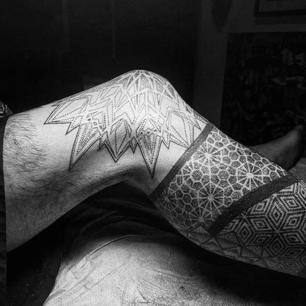 Stippling style black ink leg tattoo of various ornaments