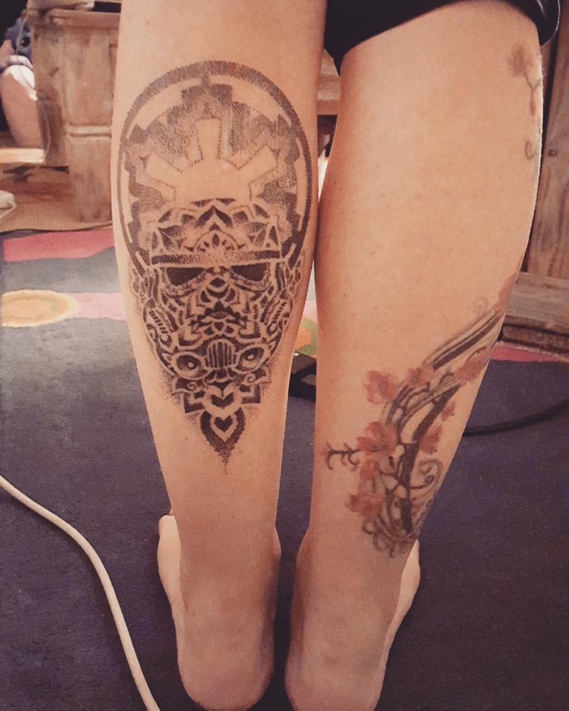 Stippling style black ink leg tattoo of Storm trooper with various ornaments