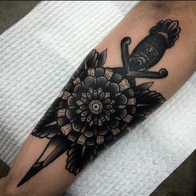 Stippling style black ink leg tattoo of flower with dagger