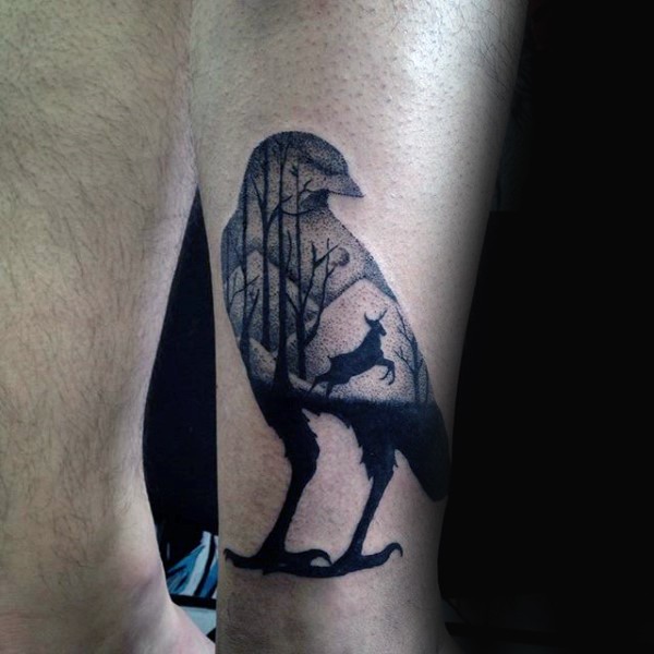 Stippling style black ink leg tattoo of bird shaped tattoo stylized with forest and deer