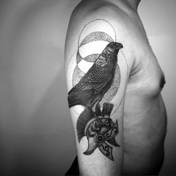 Stippling style black ink shoulder tattoo of crow with soldier helmet
