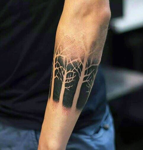 Stippling style black ink typical forearm tattoo of forest
