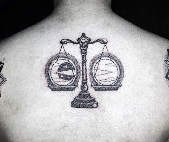 Stippling style black ink upper back tattoo of libra with moon and sun