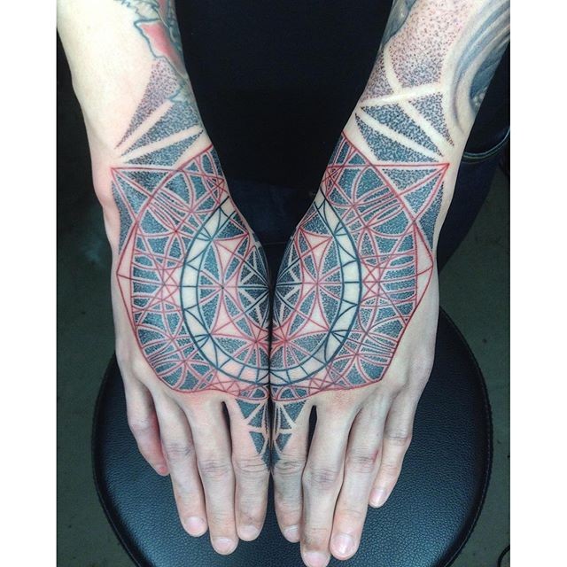 Stippling style colored hand tattoo of various ornaments