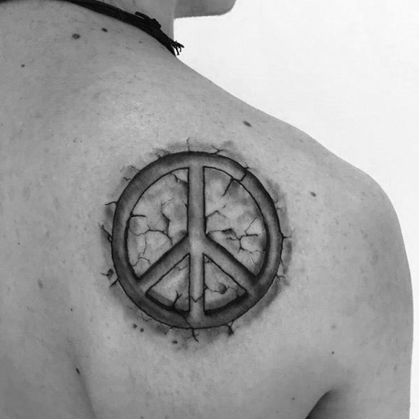 Stone like black and white shoulder tattoo of pacific symbol