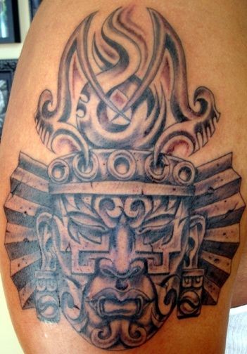 Stone mask of aztec deity tattoo