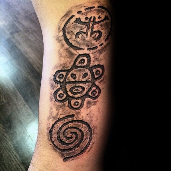 Stonework style black ink arm tattoo of various antic symbols