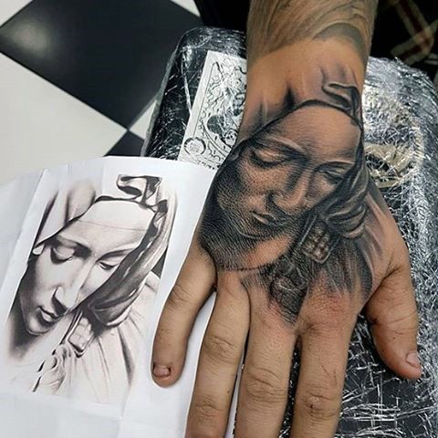 Stonework style black ink hand tattoo of sad woman in hood