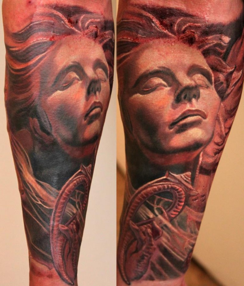 Stonework style colored forearm tattoo of woman statue