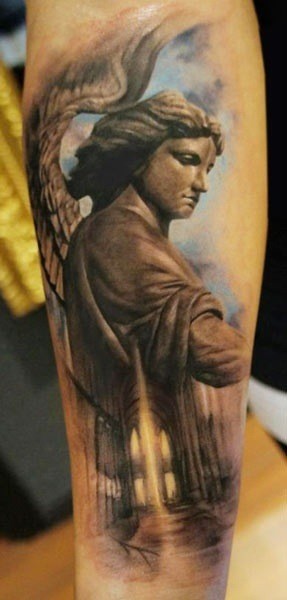Stonework style colored forearm tattoo of angel statue in old cathedral