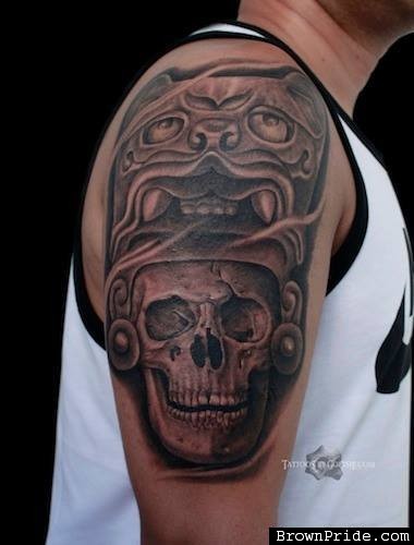 Stonework style colored shoulder tattoo of human skull with demonic helmet