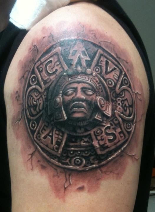 Stonework style colored shoulder tattoo of Aztec tablet