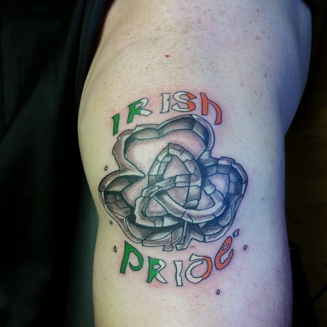 Stonework style colored tattoo of clover leaf with knot and lettering
