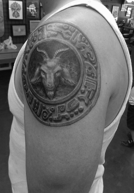 Stonework style detailed shoulder tattoo of ancient tablet with goat