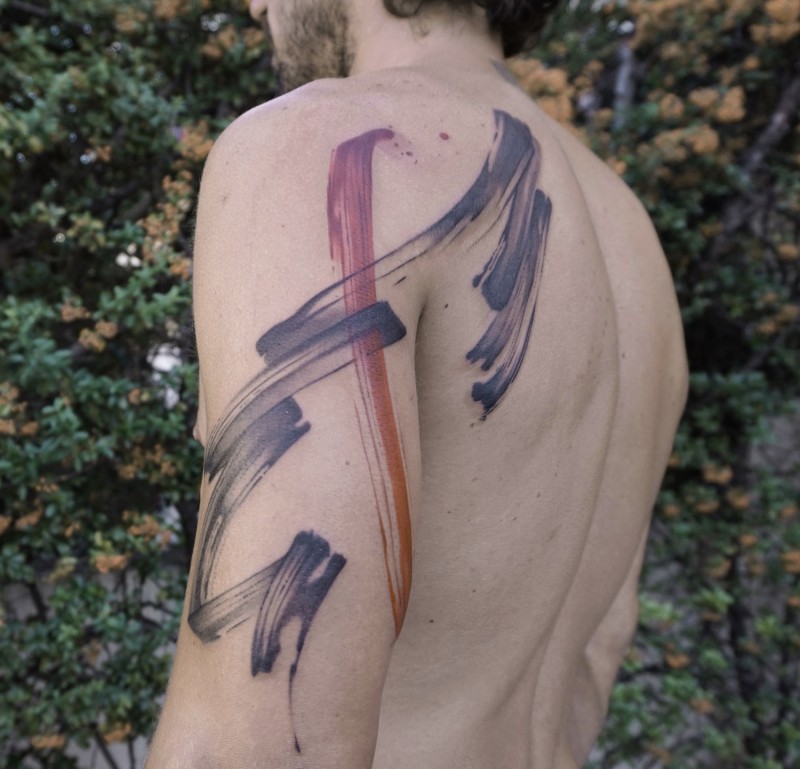 Strange designed multicolored shoulder tattoo of various stripes