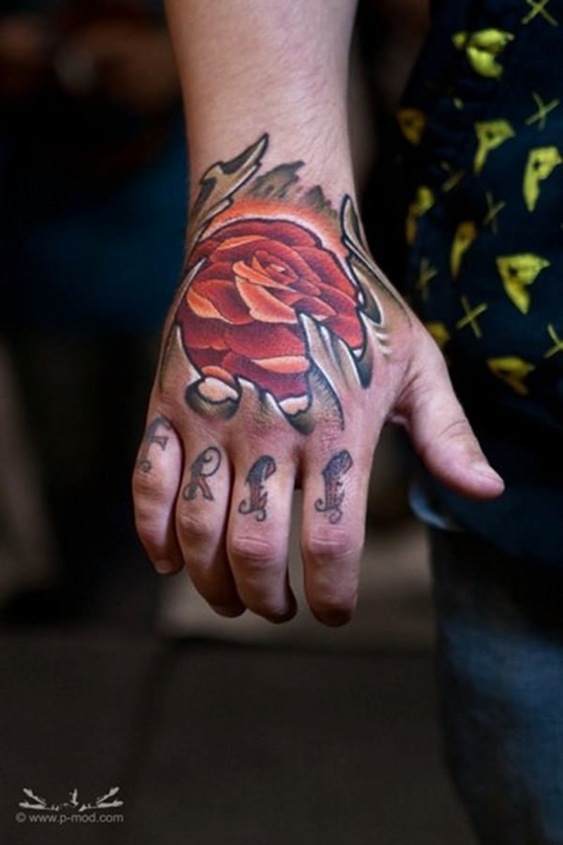 Strange designed red colored glowing rose tattoo on hand with lettering