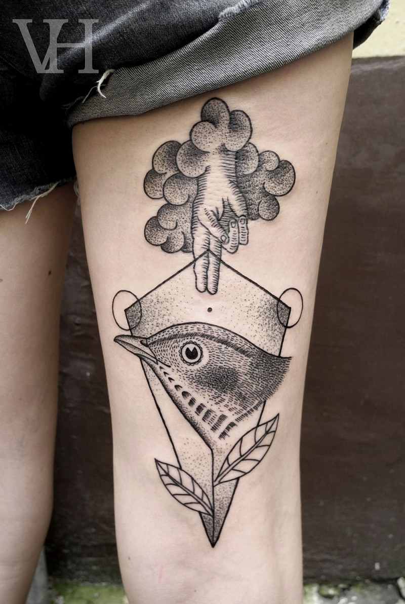 Strange looking black ink thigh tattoo of human hand with bird and leaves