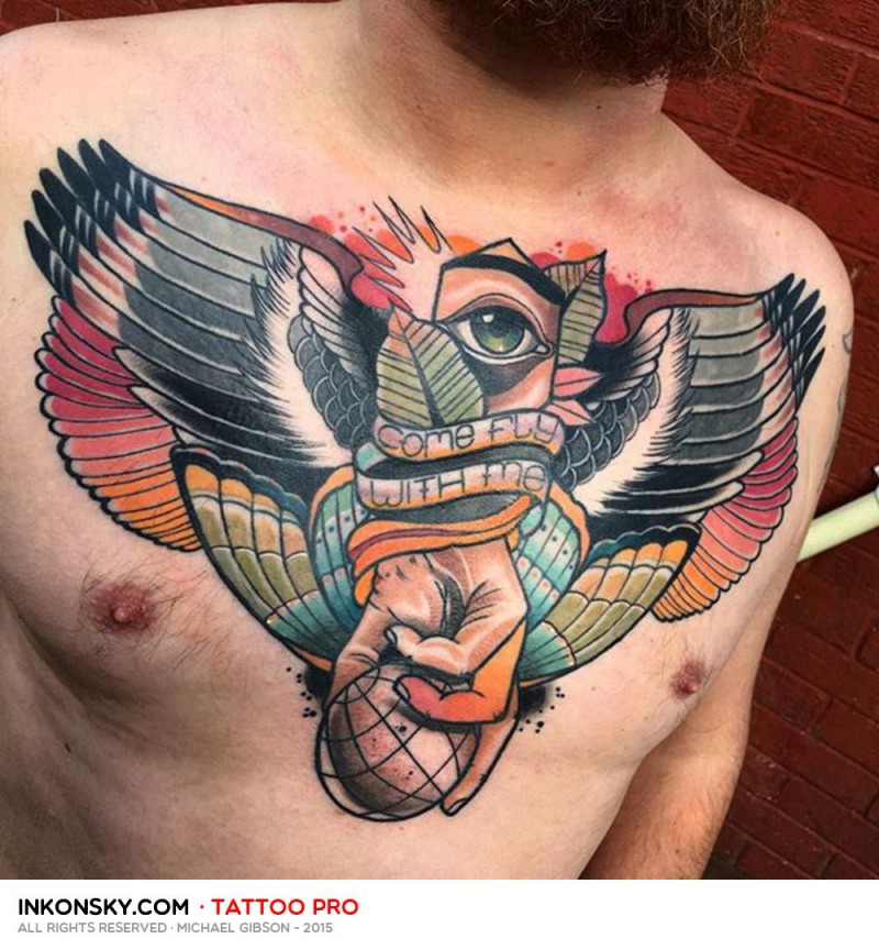 Strange looking colored chest tattoo of hand with globe and wings stylized with lettering