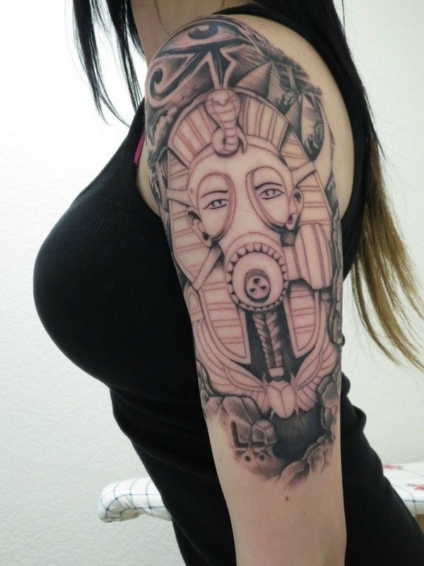 Strange looking colored Egypt pharaoh statue in gas mask tattoo on shoulder