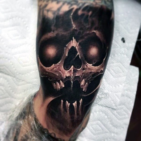 Strange looking colored tattoo of demonic skull