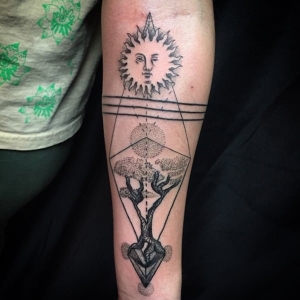 Strange looking dotwork style forearm tattoo of tree and sun