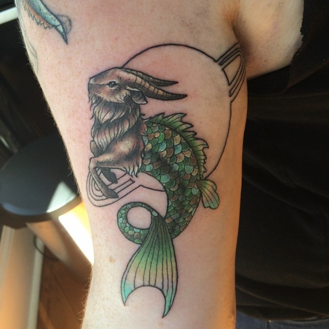 Strange style colored arm tattoo of half goat half fish creature