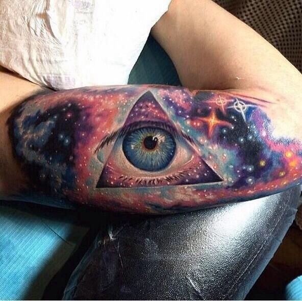 Stunning 3D like multicolored eye in space tattoo on arm