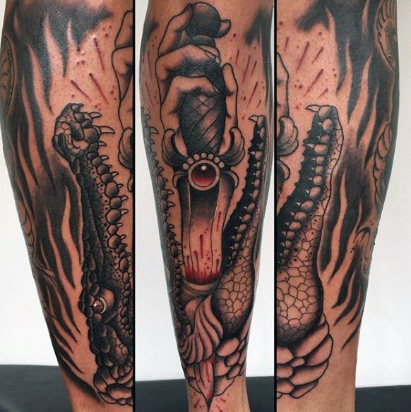 Stunning black and white alligator with bloody sword tattoo on leg