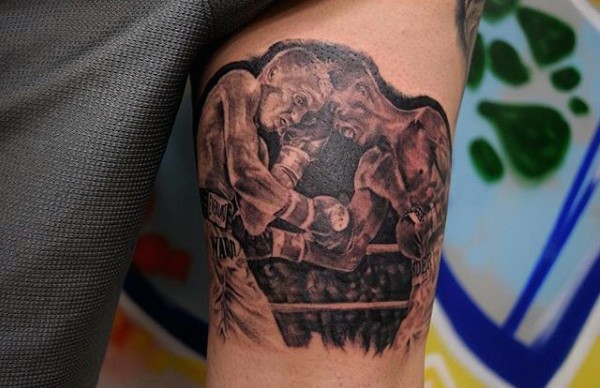 Stunning black and white boxers fight tattoo on thigh