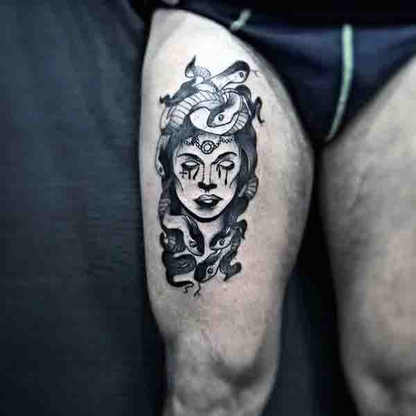 Stunning black and white Medusa head tattoo on thigh