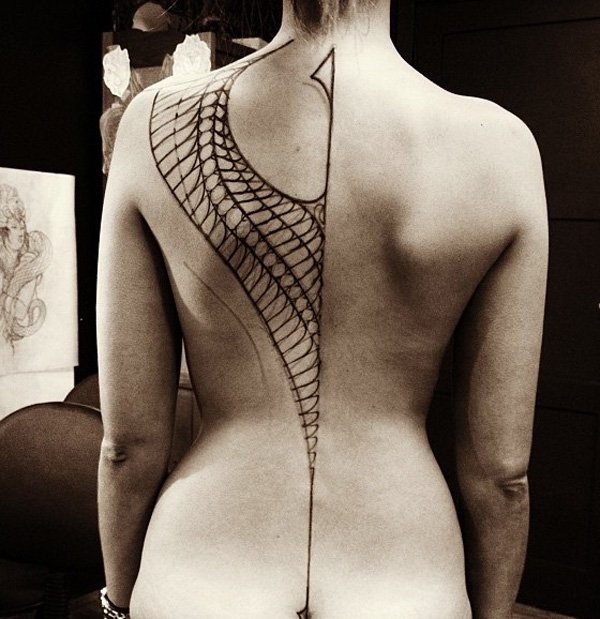 Stunning black ink unfinished Wong shaped on whole back tattoo with long line