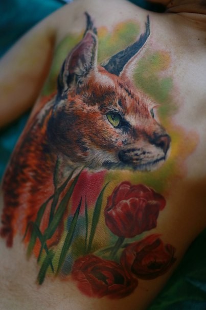 Stunning breathtaking looking colored realism style back tattoo of wild cat with flowers