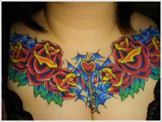 Stunning colored big roses with heart tattoo on chest