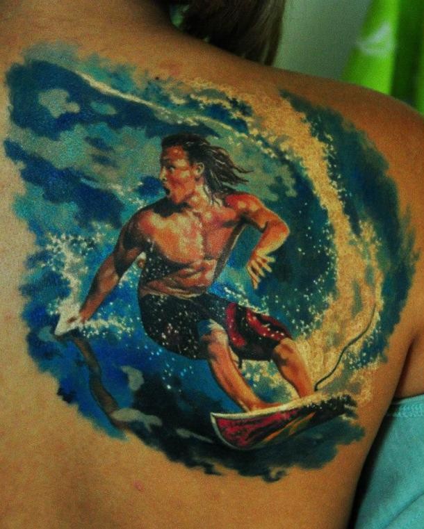 Stunning colored scapular tattoo of surfer in big wave