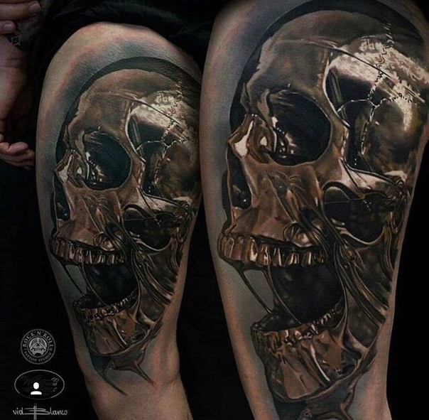 Stunning colored thigh tattoo of big iron human skull