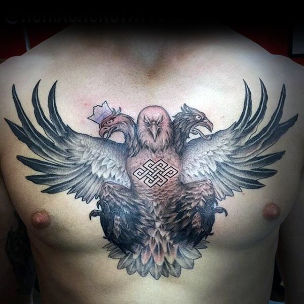 Stunning designed and colored big eagle with several heads tattoo on chest